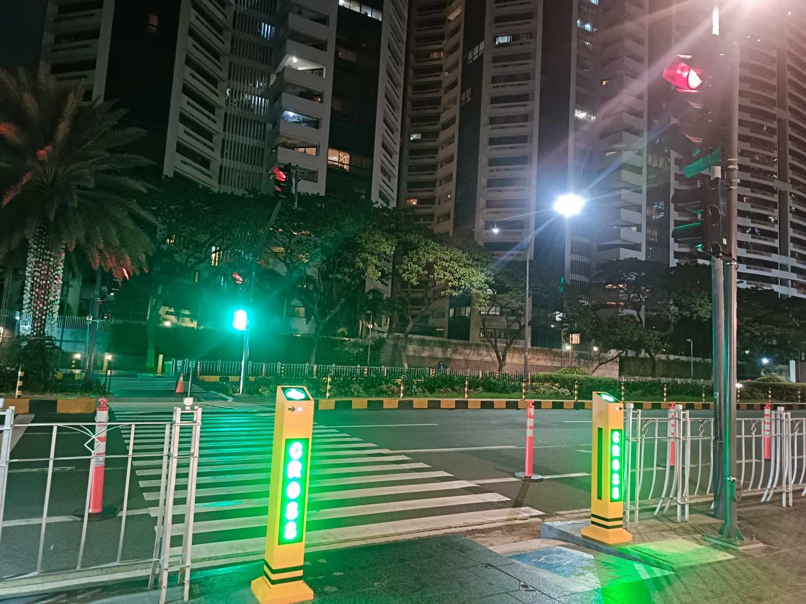 Pedestrian midblock signal installed by M3P Builders for the Makati Parking Authority, lit green at night